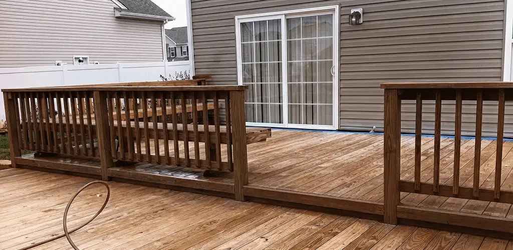 Deck sealing service protecting a backyard wood deck and railings in Yonkers, NY