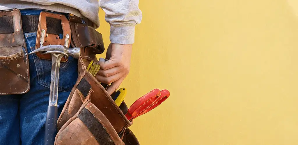 Handyman with tool belt ready for home repairs and maintenance in Yonkers, NY