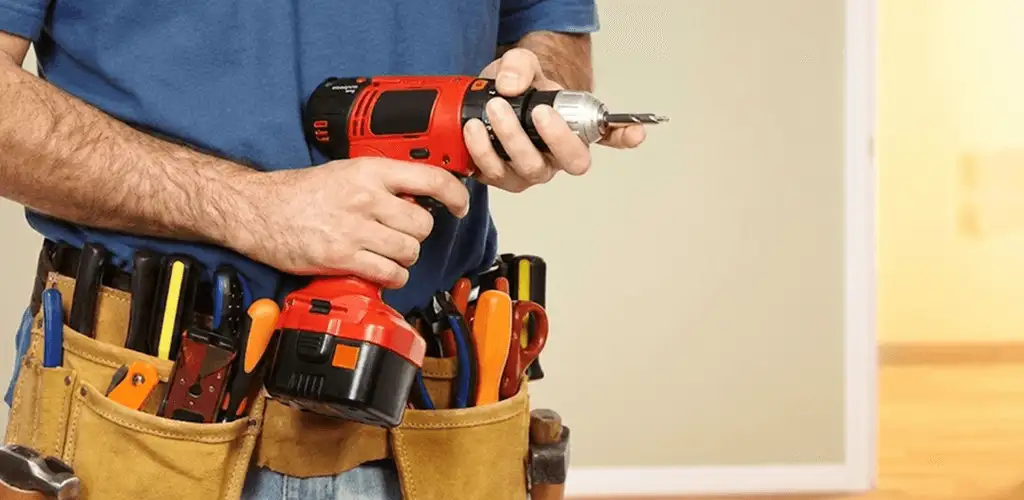 Handyman holding a power drill for home repairs and installations in Yonkers, NY