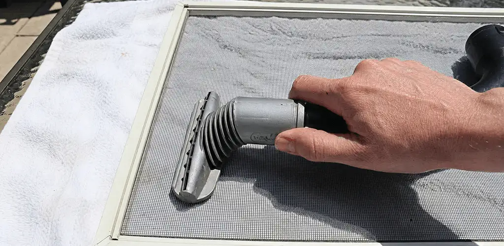 Window screen repair cleaning and fixing a damaged screen mesh in Yonkers, NY